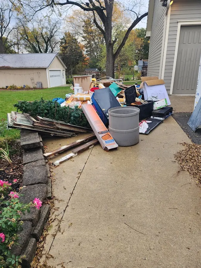 Dumpster being loaded with debris for 12 Yard Dumpster Rental in Boardman